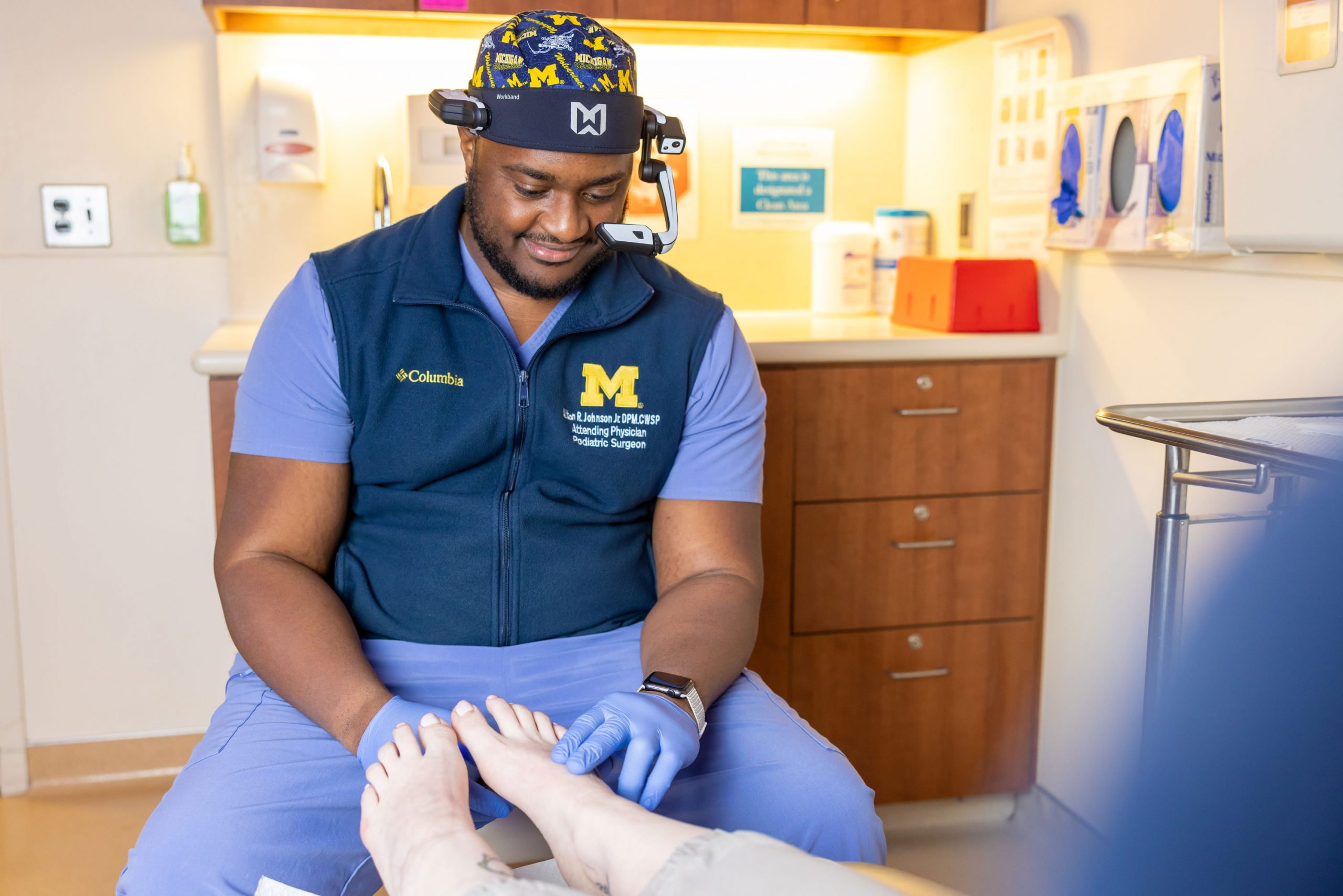 Dr. Alton Johnson Jr. examines wears Mi-VEST to perform a foot exam