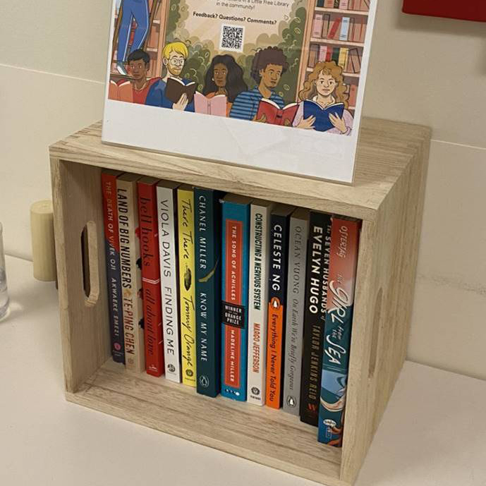 A small bookshelf containing diverse literature that is part of the Health Equity Literature Archive